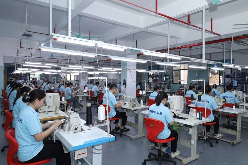 Organized Vansholcare production floor in Dongguan with functional apparel manufacturing lines