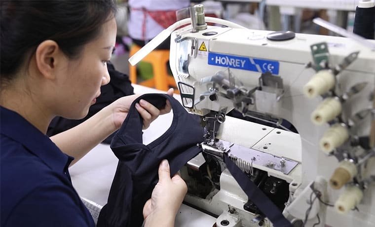 Precision sewing workshop with skilled operators making private-label period care garments
